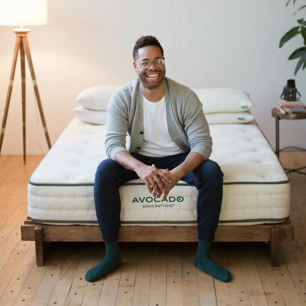 Avocado mattress with man sitting on it